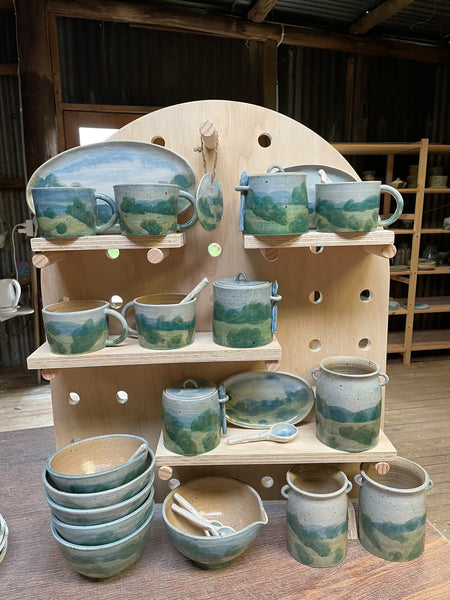 Arch shaped pegboard set displaying Mountain Clay Ceramics